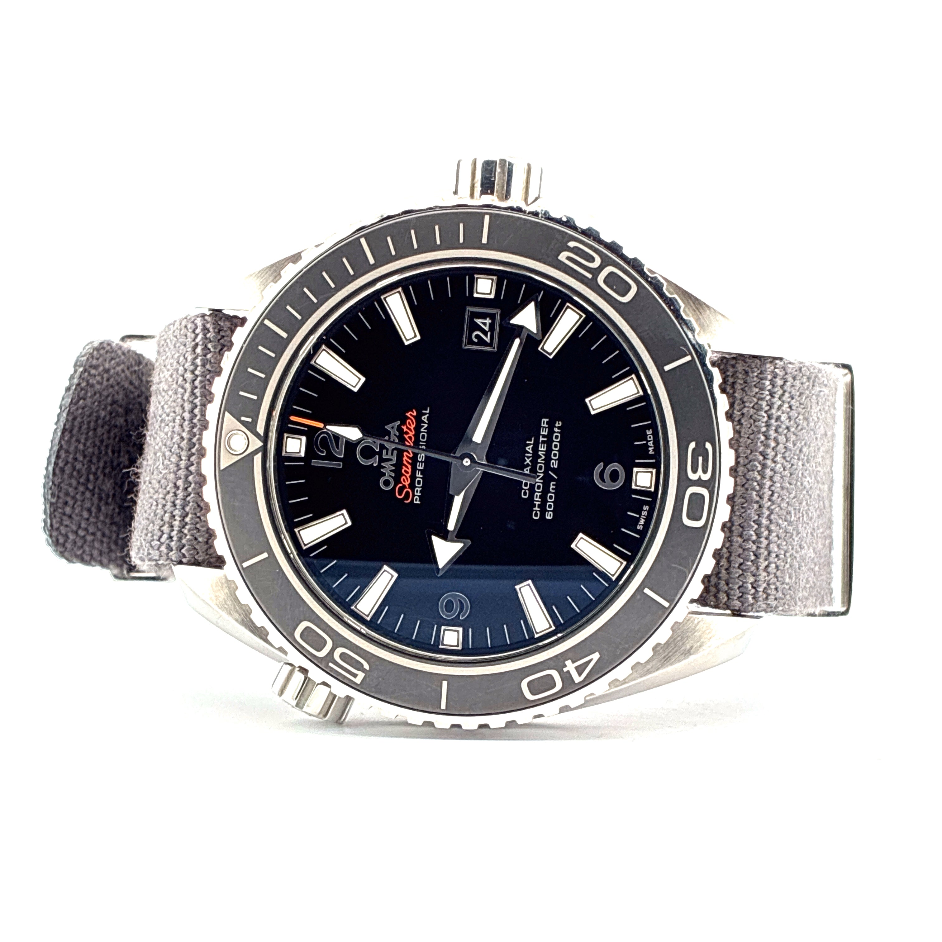 Omega Seamaster Planet Ocean mit schwarzem Zifferblatt, Datumsanzeige bei 3 Uhr und grauem Textilband, Frontansicht auf weissem Hintergrund