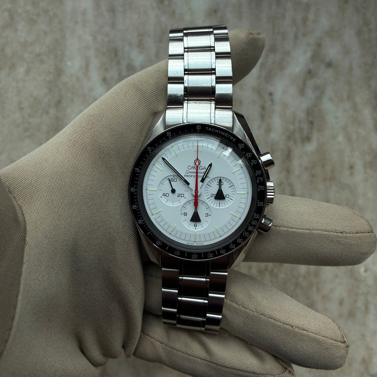 Omega Speedmaster Professional Moonwatch Alaska Project / Limited Edition / very rare / Full-Set / 2008, Vorderansicht mit Zifferblatt, Armband und Krone vor neutralem Hintergrund