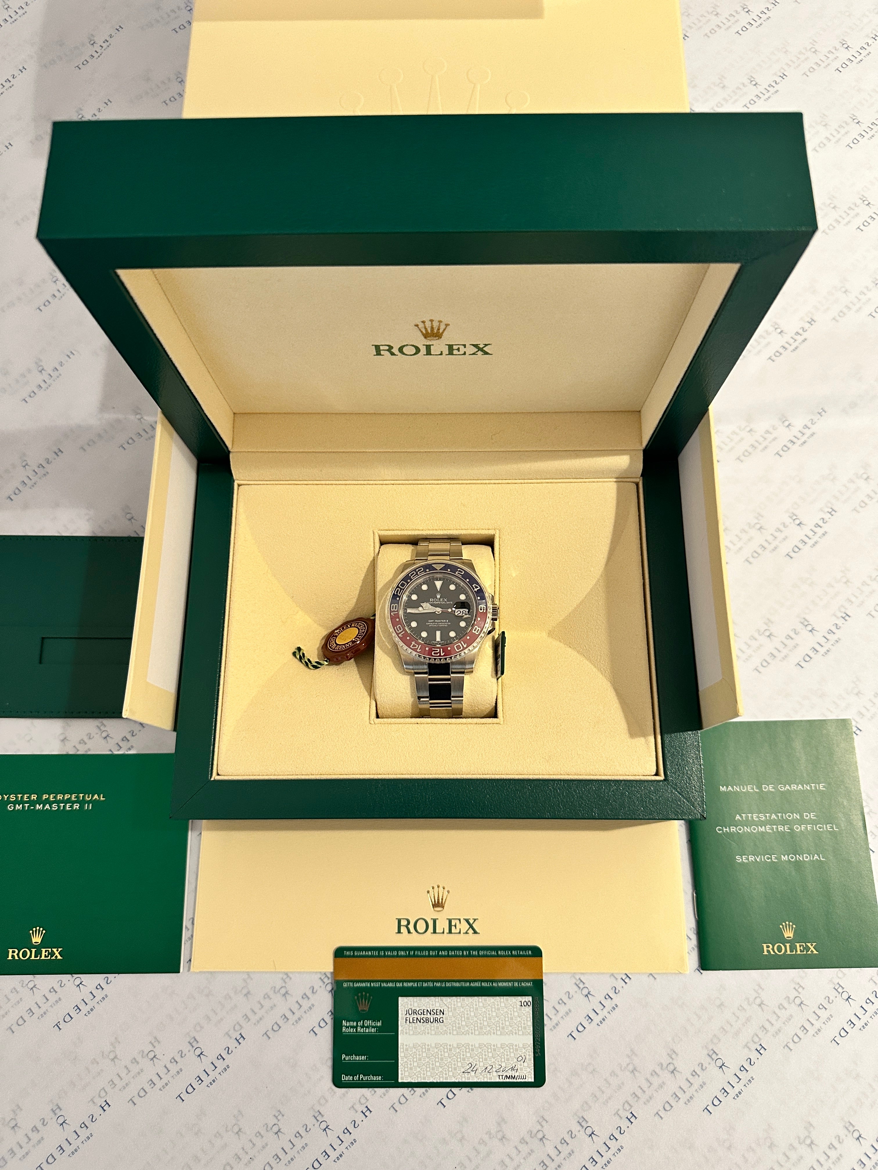 Rolex GMT-Master II Pepsi aus Weißgold in geöffneter Box mit Garantiekarte und Papieren