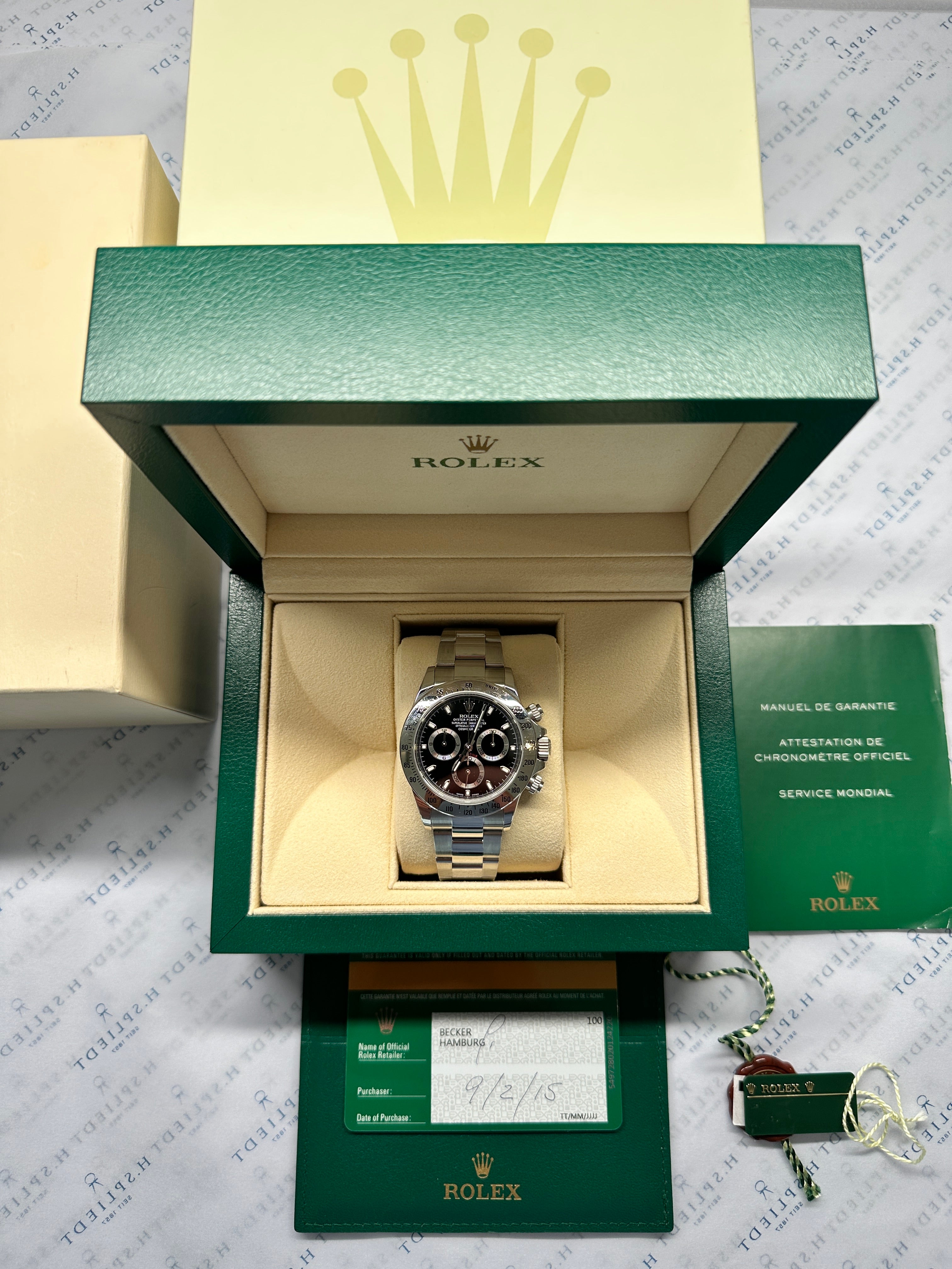 Rolex Daytona 116520 Black gebraucht im geöffneten grünen Rolex-Etui mit Garantiekarte