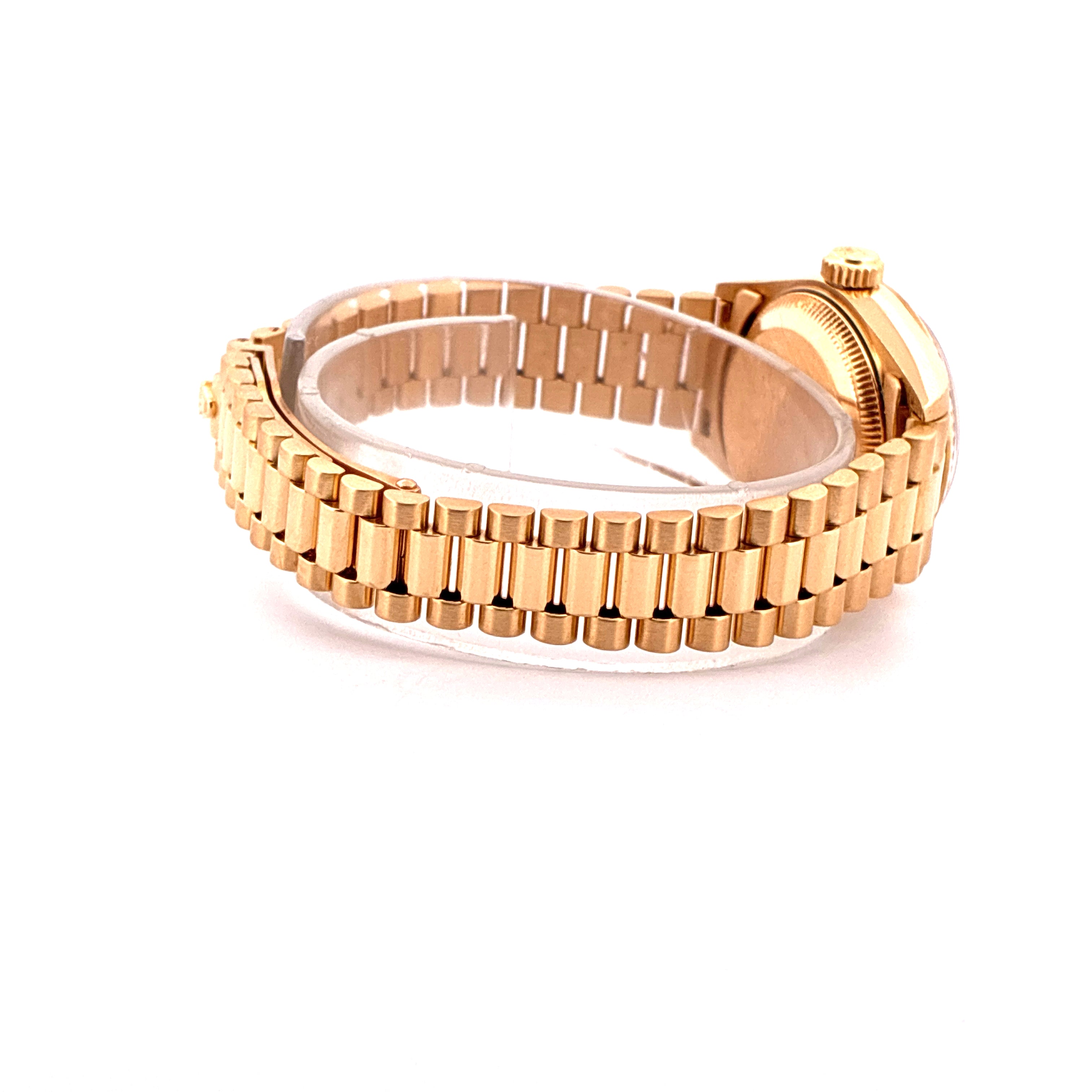 Side view of a Rolex Lady-Datejust with a gold President bracelet and case on a white background