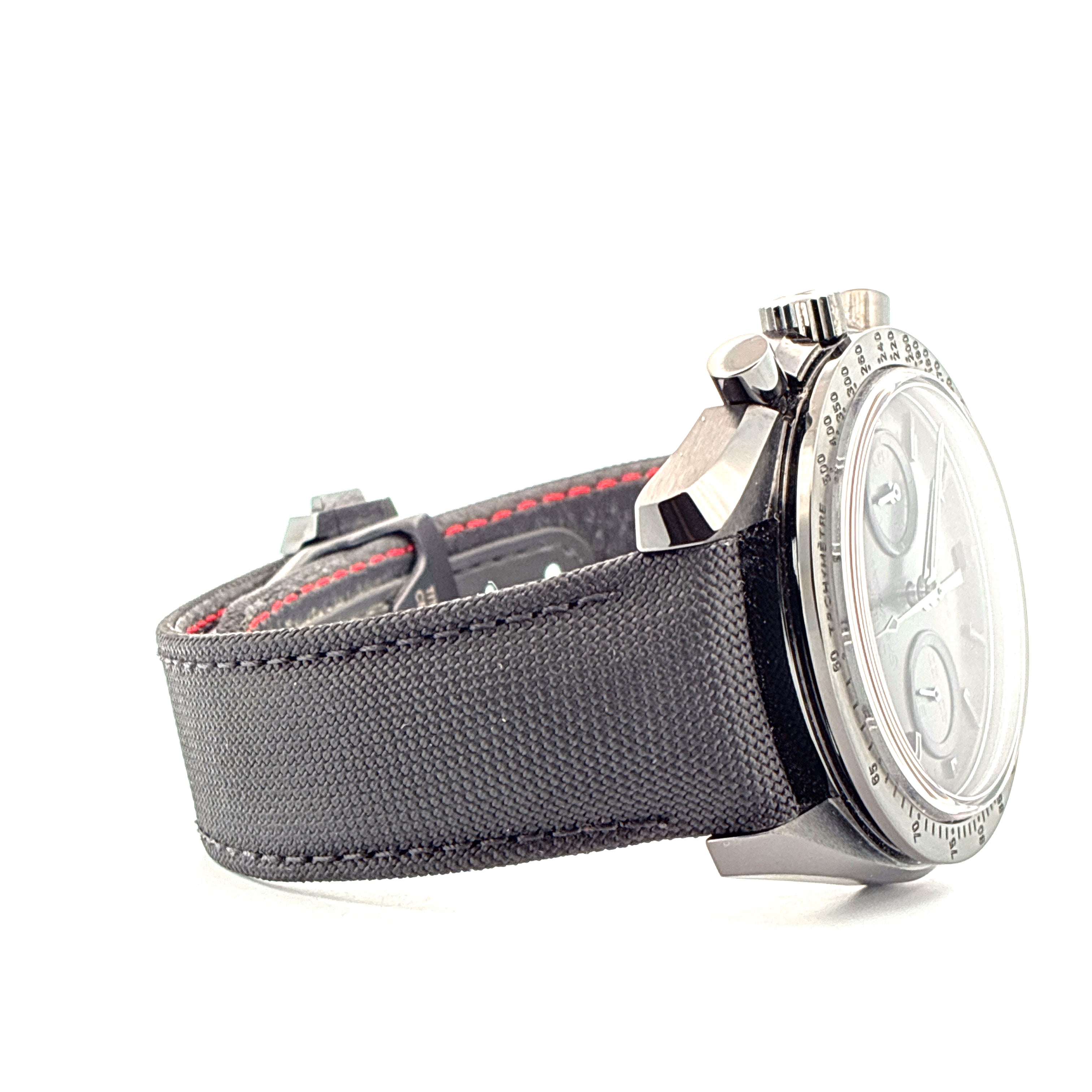 Omega Speedmaster Dark Side Of The Moon Moonwatch seitlich mit schwarzem Textilband mit roten Nähten und Tachymeter-Lünette