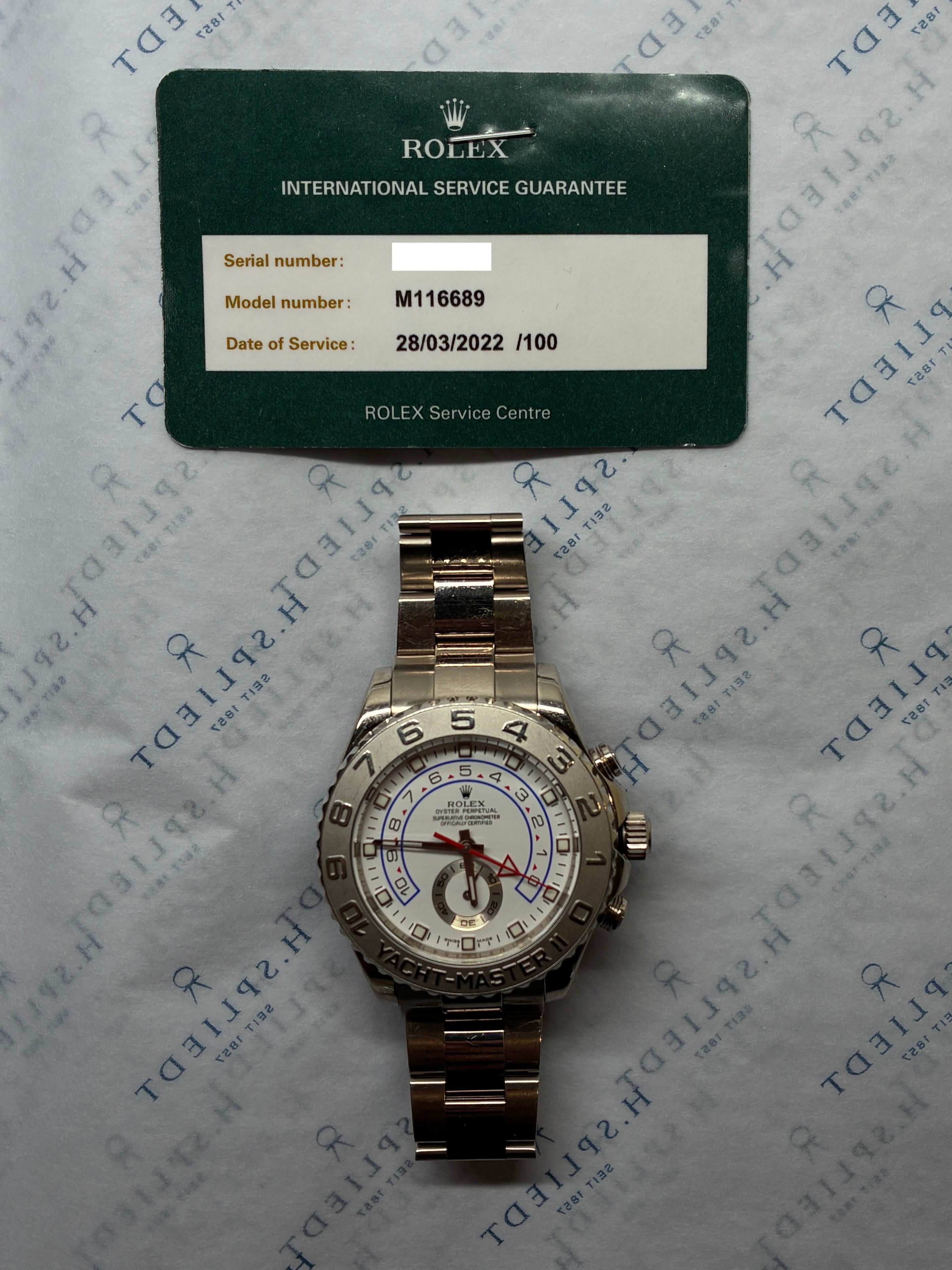 Rolex Yacht-Master II aus Weißgold, im Studio auf einer Servicekarte, die ein Datum im März 2022 zeigt