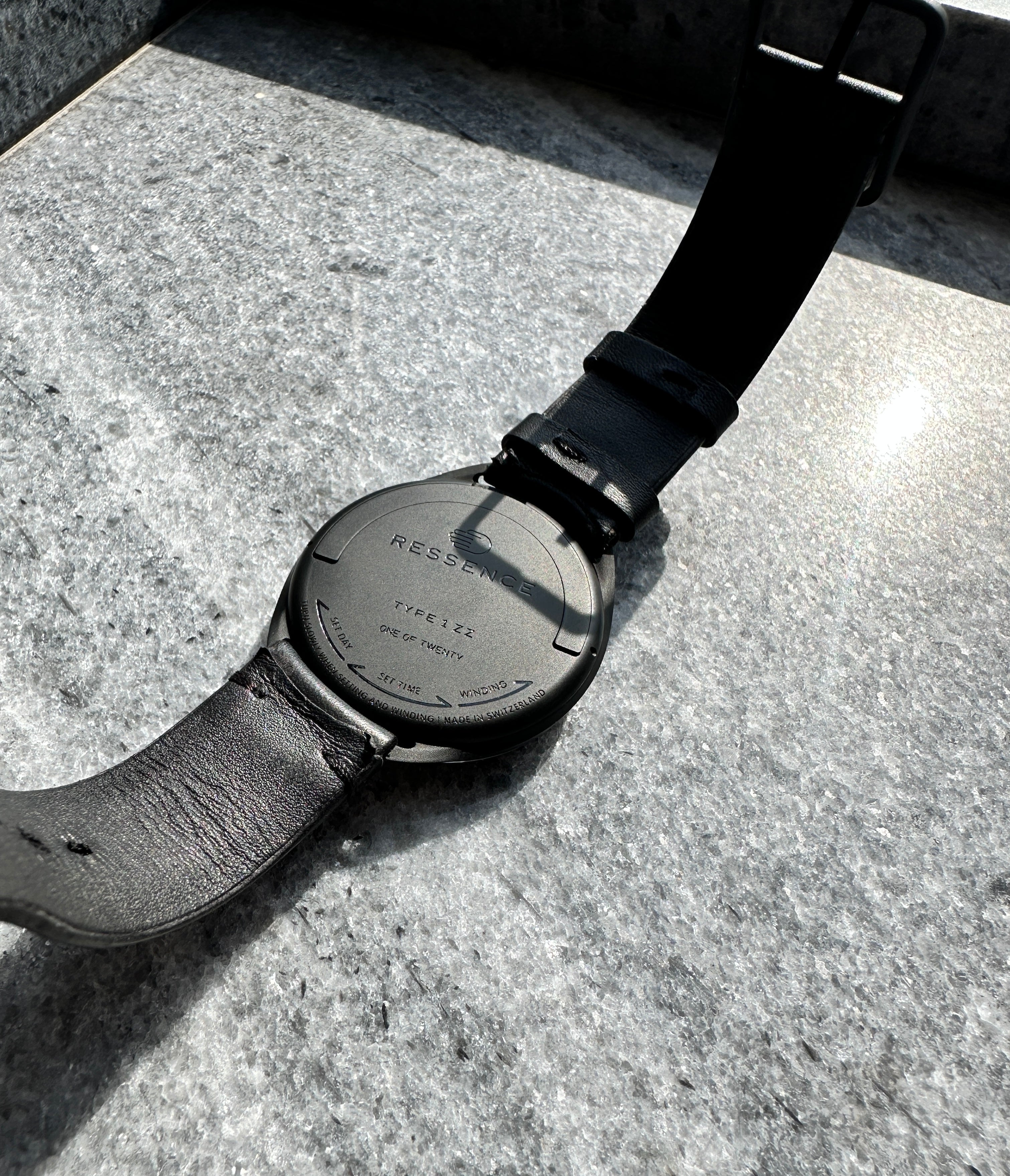 Ressence Type 1 ZZ auf Steingrund, Rückseite mit Gravur und schwarzem Lederarmband
