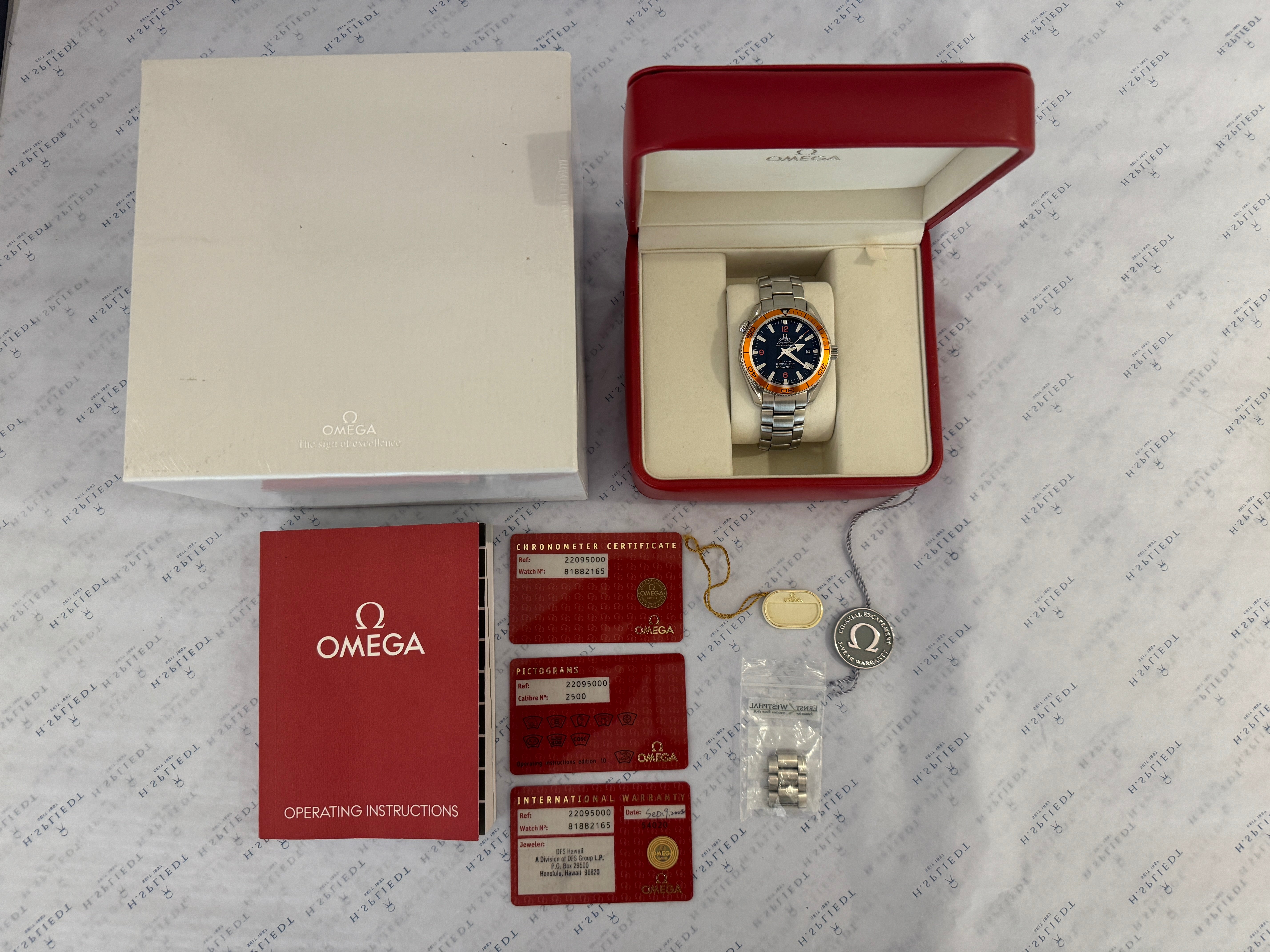 Omega Seamaster Planet Ocean 42 mm Edelstahl mit orangefarbener Lünette und Zifferblatt im Karton