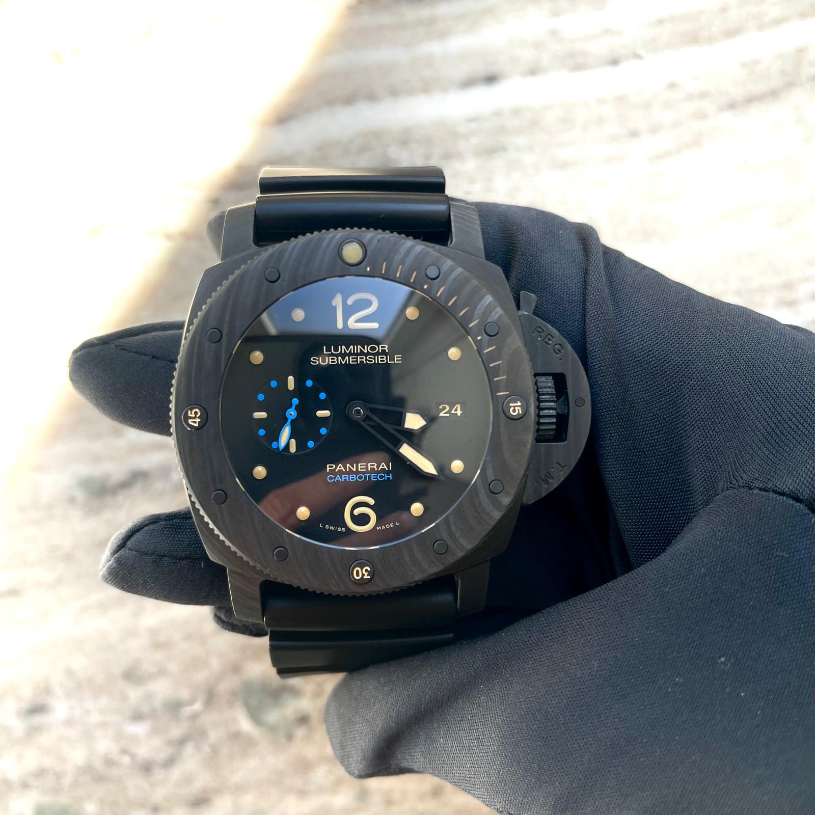 Panerai Luminor Submersible 3 Days Automatic mit schwarzem Zifferblatt, blauen Akzenten und Armband in behandschuhter Hand