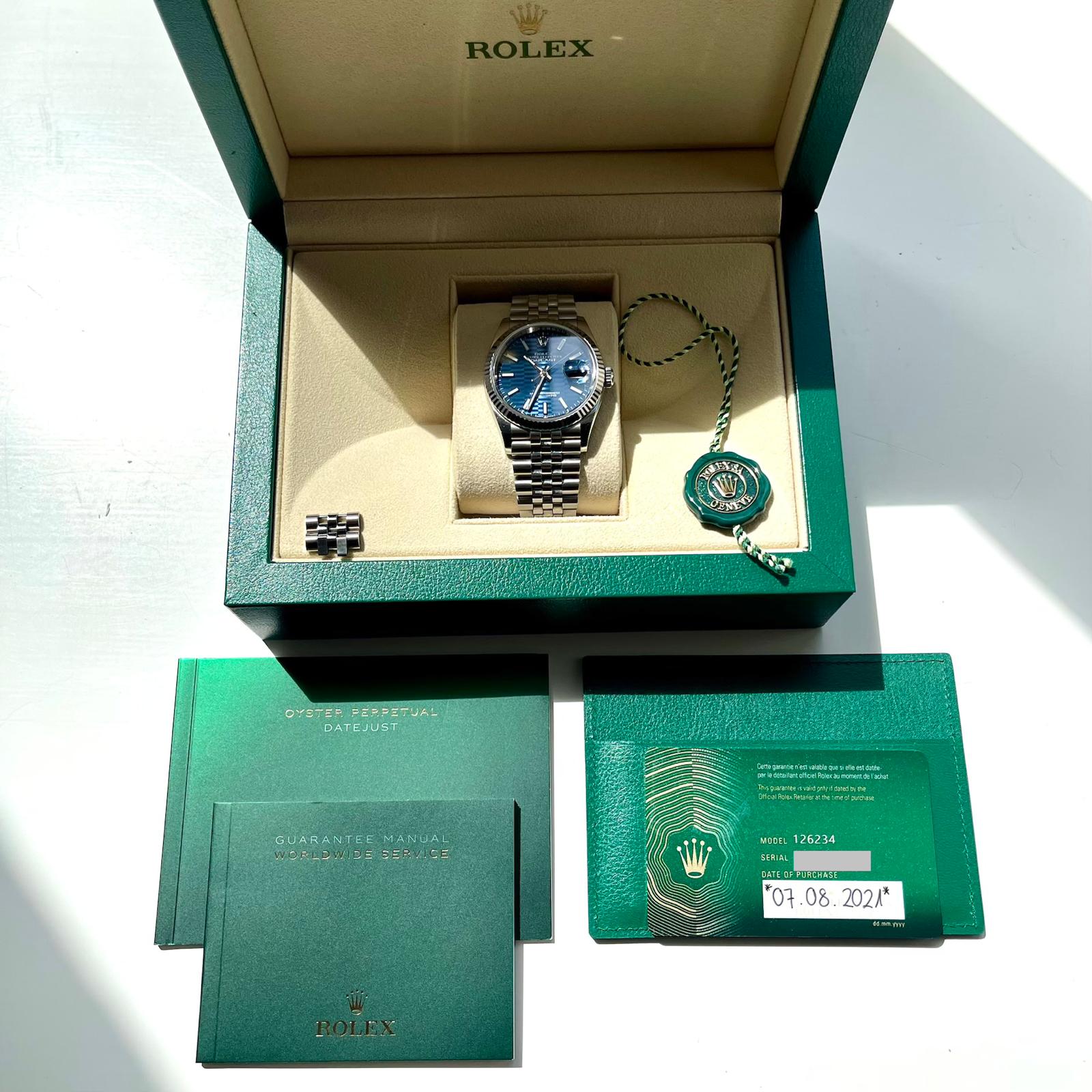 Rolex Datejust 36 mit blauem Zifferblatt in geöffneter Box mit Papieren